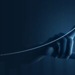 A hand drawing an increasing line, representing commercial investment.