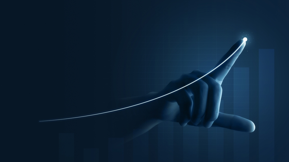 A hand drawing an increasing line, representing commercial investment.